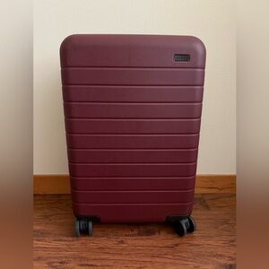 Away Bigger Carry On luggage in “Brick” color